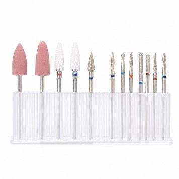 A set of 12 manicure drill bits in a container with a stand.